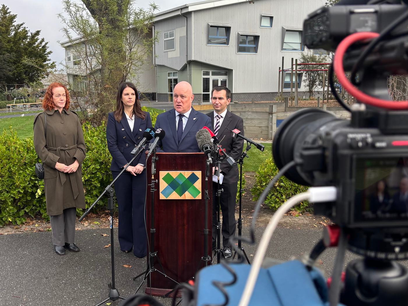 Camera operator filming a Prime Ministerial press conference at a Christchurch school